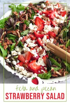 a salad with strawberries, pecans and feta cheese on top in a white bowl