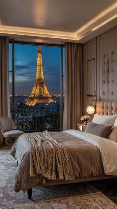 a bedroom with a view of the eiffel tower in paris, france at night