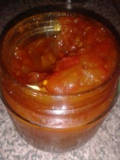 a glass jar filled with food sitting on top of a counter