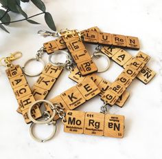 wooden keychains with the names of different types of letters and numbers on them