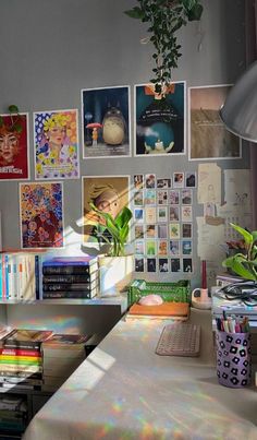 a desk with some books and pictures on the wall