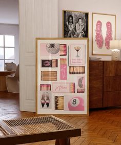 a wooden table sitting next to a wall with pictures on it