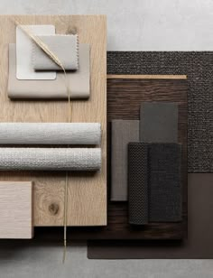 various materials are laid out on top of a wooden surface, including carpeting and wall coverings