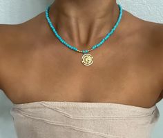 𝐄𝐗𝐐𝐔𝐈𝐒𝐈𝐓𝐄 𝐓𝐔𝐑𝐐𝐔𝐎𝐈𝐒𝐄: Elevate your style with a turquoise necklace featuring carefully selected turquoise beads and a stunning coin pendant 𝟏𝟒𝐊 𝐆𝐎𝐋𝐃 𝐅𝐈𝐋𝐋𝐄𝐃: Indulge in the opulence of a celestial necklace adorned with high-quality 14K gold filled accents for a timeless and elegant touch 𝐆𝐋𝐎𝐑𝐈𝐎𝐔𝐒 𝐅𝐔𝐒𝐈𝐎𝐍: Unleash the allure of gemstones seamlessly combined with gold balls, creating a magnificent and radiant accessory that captivates attention 𝐓𝐈𝐌𝐄𝐋? Turquoise Necklace With Coin Pendant As A Gift, Turquoise Necklaces With Coin Pendant Medallion, Gold Turquoise Necklace With Round Beads For Gift, Spiritual Turquoise Medallion Necklace, Turquoise Medallion Locket Jewelry, Turquoise Necklaces, Contemporary Jewelry Design, Celestial Necklace, Turquoise Bead Necklaces