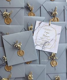 many gray envelopes with gold and silver decorations