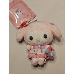 a small stuffed animal with a pink outfit