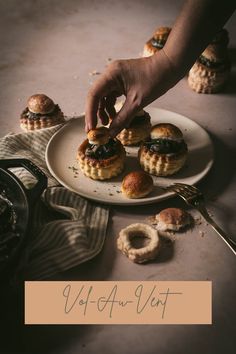 a person reaching for some food on a plate with the words vod au ventt above it