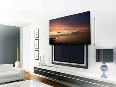 a large flat screen tv mounted to the side of a wall in a living room