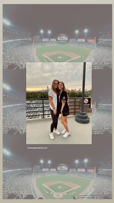 two people standing in front of a baseball field