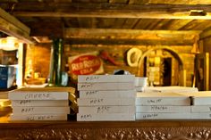 several stacks of pizza sitting on top of a wooden table next to a red sign