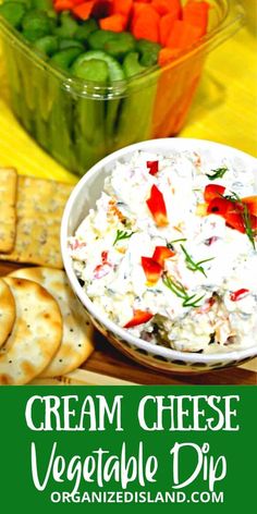 a bowl of cream cheese vegetable dip next to crackers