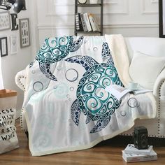 a white couch with a blue turtle blanket on it