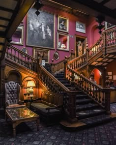 an ornate staircase with pictures on the wall