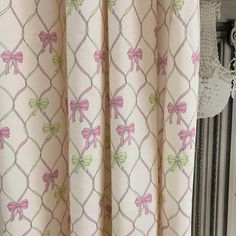 a curtain with pink and green bows on it