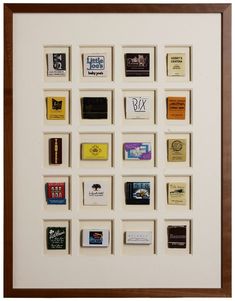 a white framed artwork with many different types of books on it's sides and brown trim around the edges