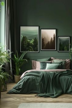 a bedroom with green walls and pictures on the wall above the bed, along with potted plants