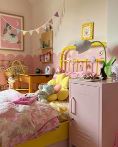 a child's bedroom with pink and yellow decor