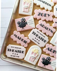 decorated cookies in the shape of movie characters are on a tray with white and pink icing