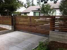 a wooden fence in front of a house