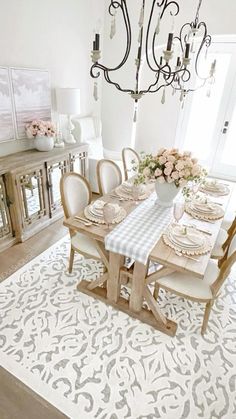 the dining room table is set with place settings