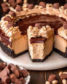 a chocolate peanut butter cheesecake on a white plate with two pieces missing from it