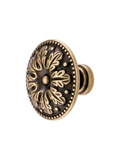 an antique brass cabinet knob with floral design on the front and side, set against a white background