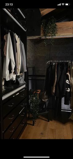 an organized closet with clothes hanging on rails