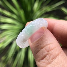 Certified Natural Type A Carved Jadeite Ring A thick carved white with a dash of green jadeite ring. This jadeite band ring has a mixture of glutinous and bean variety. Hence, it has some grain aggregate texture and patches of white inclusions or "white clouds". Likewise it is opaque with some parts lightly translucent. No stone lines or rough surfaces. It is thickly cut and comes with a certificate. Unisex ring suitable for ladies and gentlemen. The black and white backgrounds are taken indoors, the rest of photos are taken under natural outdoor light. The approximate dimensions are as follows :  Gemstone : Natural Type A Carved Jadeite Ring US ring size : 7.5 Inner diameter : 18.7 mm  Width : 6.3 mm Saddle thickness : 3.7 mm  Weight : 4.10 g Gemstone certified by www.zkzbjd.cn Internatio White Jade Gemstone Rings, White Oval Carved Rings, Oval Carved White Ring, White Oval Carved Ring, White Carved Ring For Anniversary, White Carved Anniversary Ring, White Jade Rings For Anniversary, Jadeite Ring, Bean Varieties