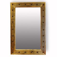 a wooden frame with metal rivets on the sides and a mirror above it