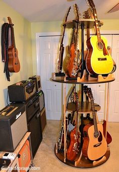 there are many guitars on the shelf in this room