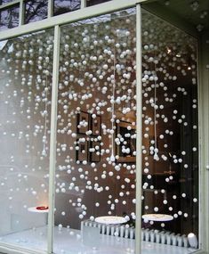 the window is decorated with white balls