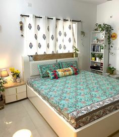 a bed room with a neatly made bed and a book shelf on the wall next to it