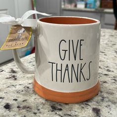 a coffee mug with the words give thanks on it