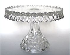 a clear glass cake plate on a white table