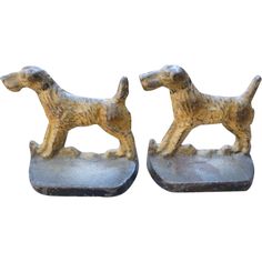 two small figurines of dogs standing on top of each other