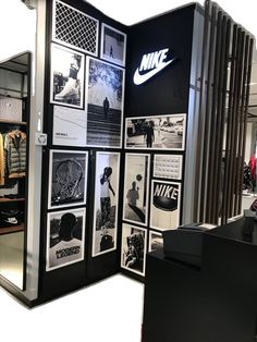 a display case with nike pictures on the front and back wall in an office setting