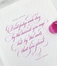 a pink ink pen sitting on top of a piece of paper