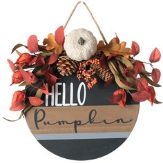 a wooden sign that says hello pumpkin hanging from a rope with leaves and acorns