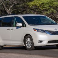 a white toyota sienna is driving down the road