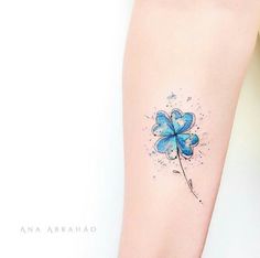 a small blue flower tattoo on the leg