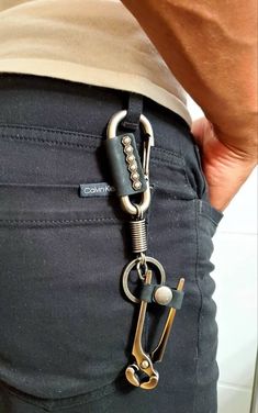 a person with a pair of scissors in their back pocket, holding onto the side of his pants