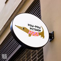 a sign on the side of a building that says poup - pou pet shop