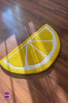 a slice of lemon sitting on top of a wooden floor