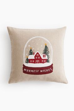 a pillow with a snow globe on it that says,'warmest wishes '