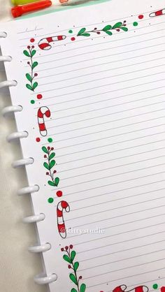 a notepad with christmas decorations and candy canes on it