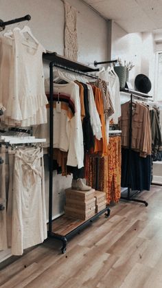 a clothing rack in a store filled with clothes