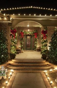 a house with christmas lights on the front door and steps leading up to it's entrance