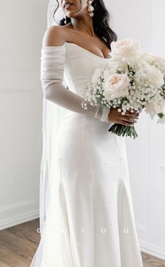 a woman in a wedding dress holding a bouquet