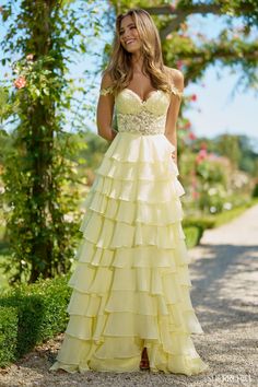 a woman in a yellow dress posing for the camera with her hands on her hips