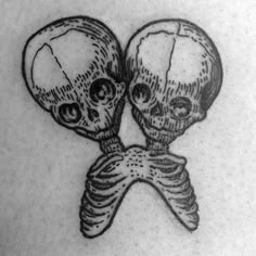 two skulls with crossed bones on their backs